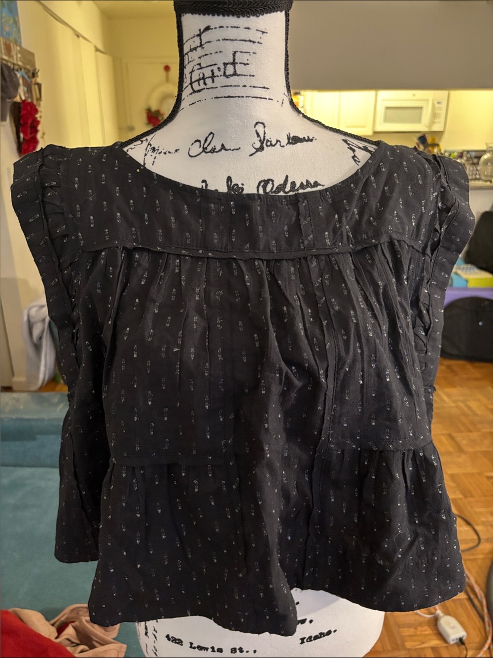 Black Cap-Sleeve Peplum  Top with Subtle sparkly detail. A-line shape.